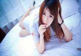 趴在床上的可爱护士服女生高清电脑桌面壁纸